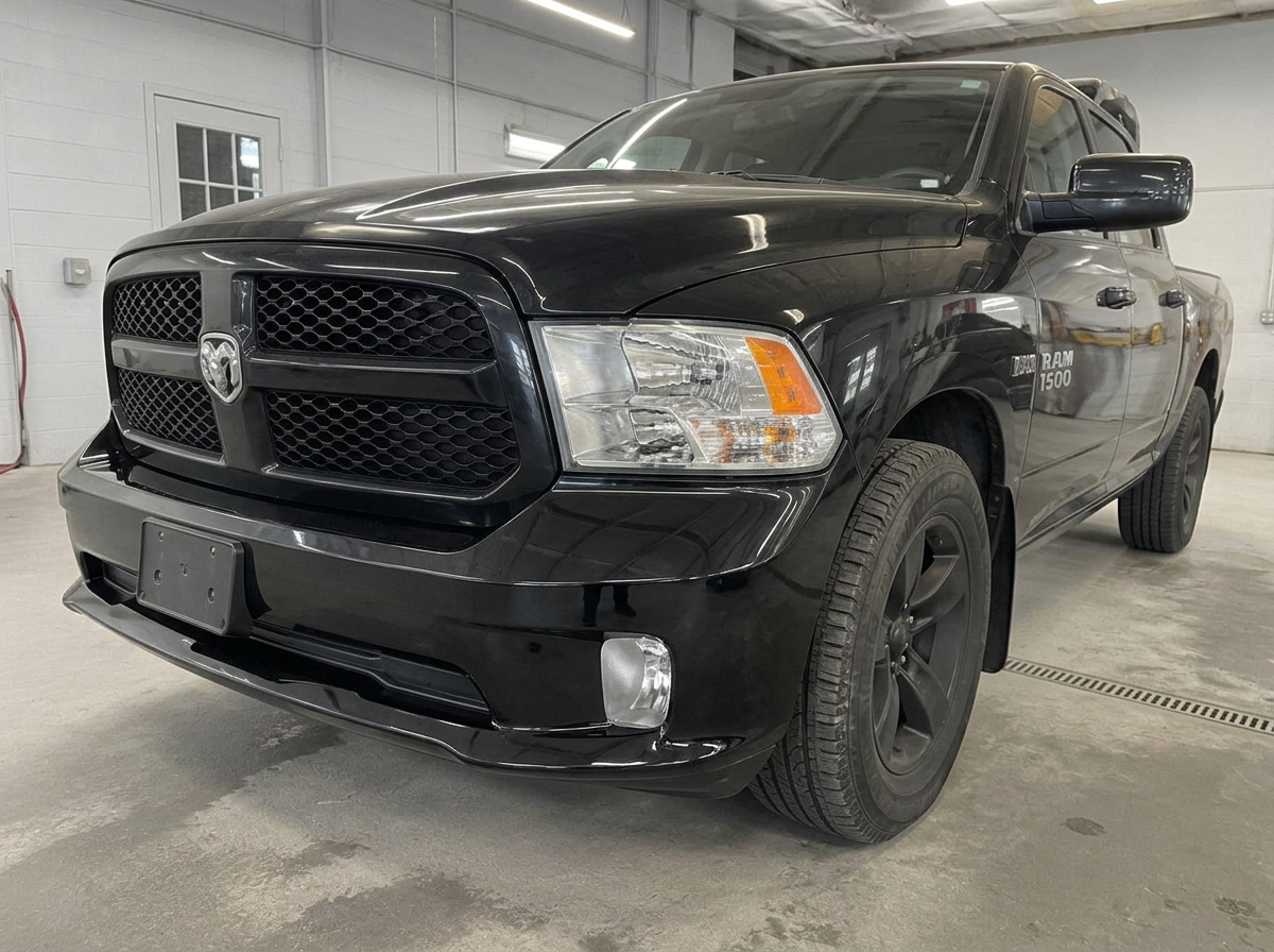 The same black pickup truck front bumper restored and repainted after repair