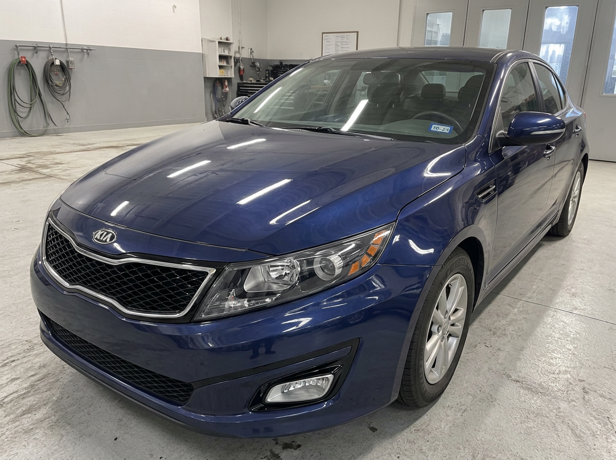 The same dark blue sedan with straight panels and a new headlight after accident repair