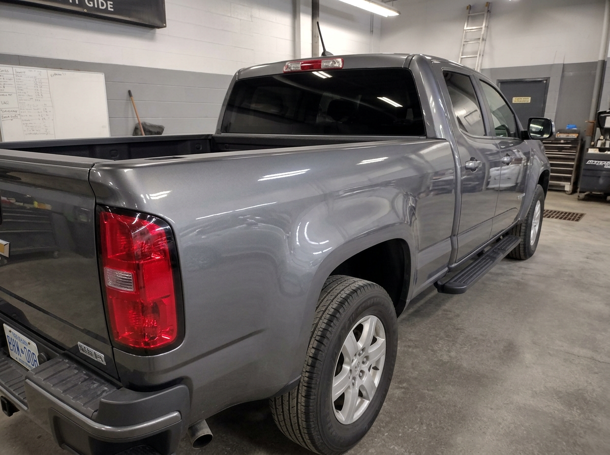 The same gray pickup truck bed side straight and repainted after body shop repair