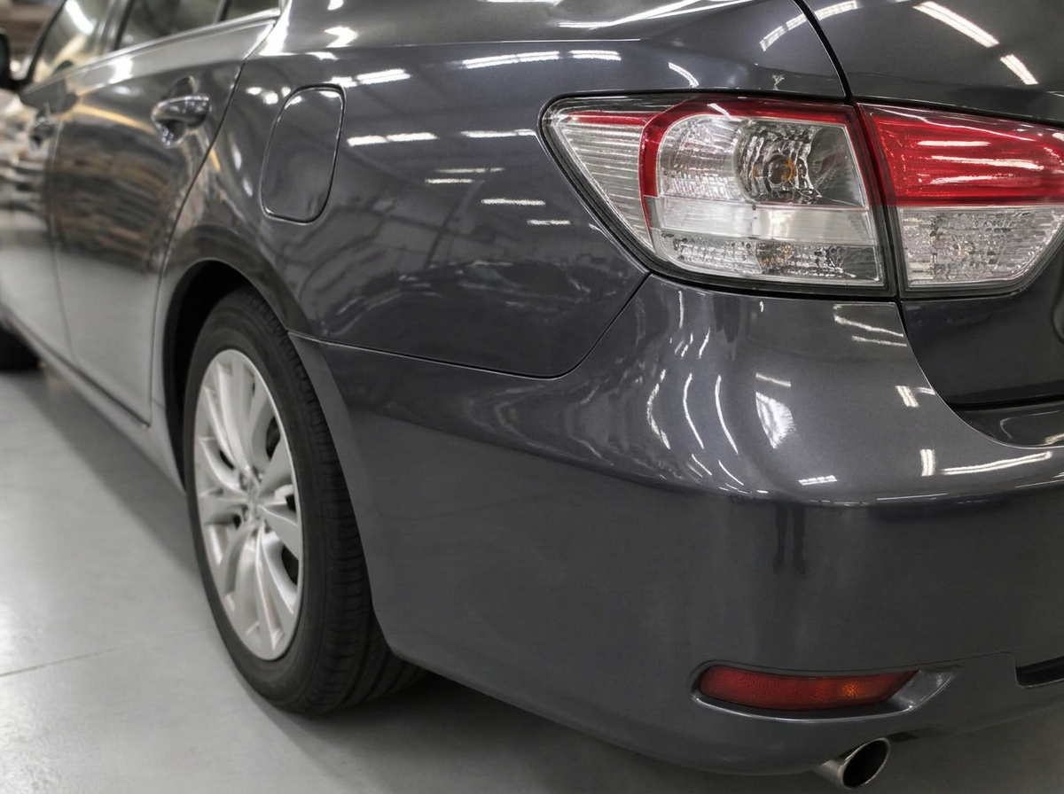 The same charcoal gray sedan rear quarter panel straight and refinished after repair