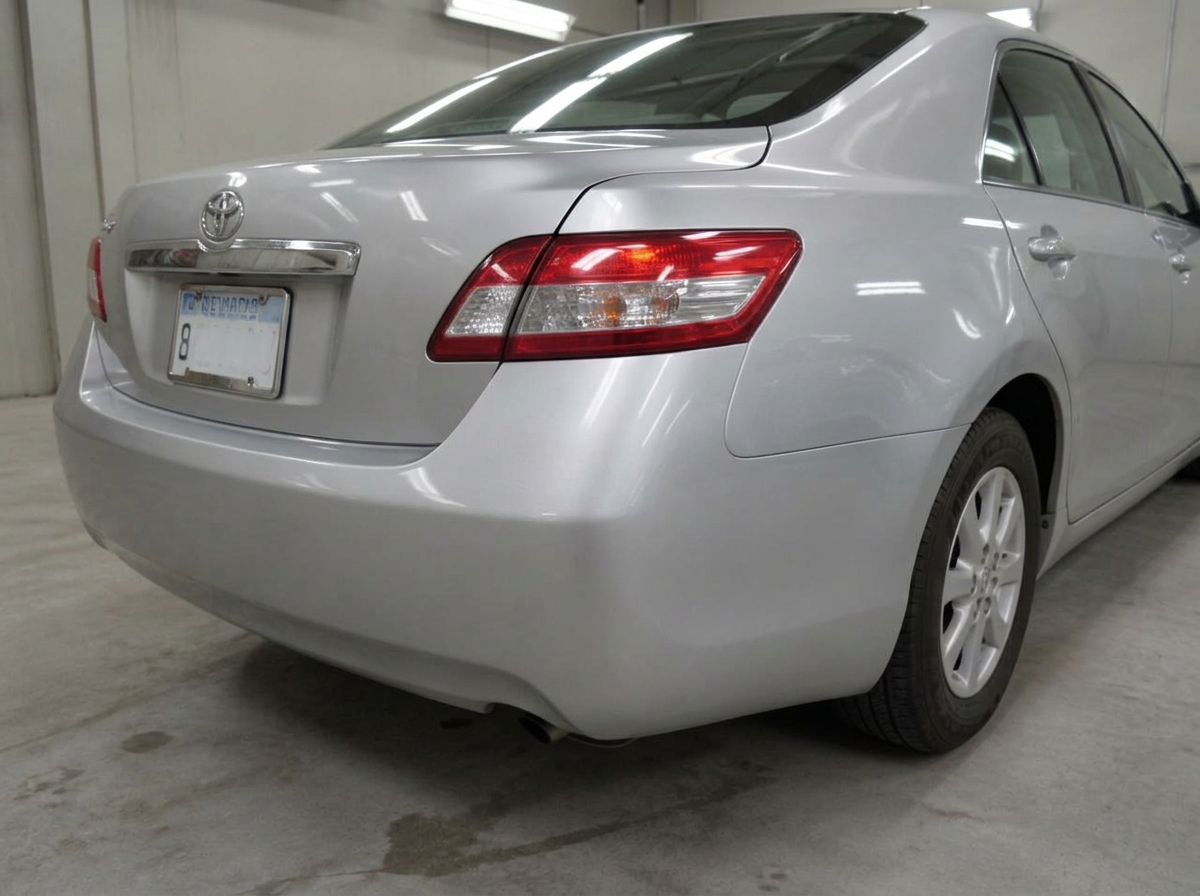 The same silver sedan rear bumper smooth and refinished after bumper repair